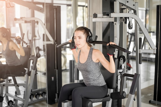 Pretty young sport woman is Workout in gym