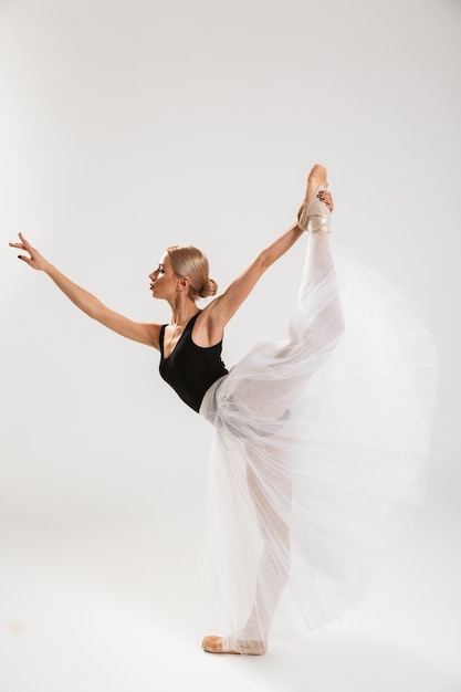 Pretty young woman ballerina dancing gracefully