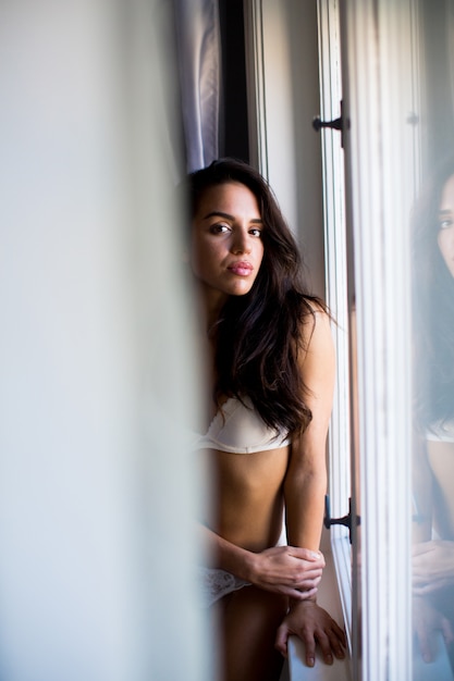 Pretty young woman by the window