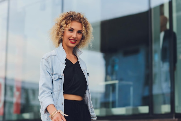 Pretty young woman in casual clothes inside trade centre background