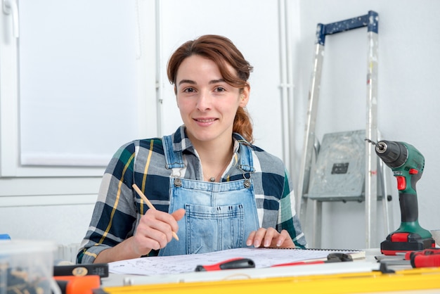 Pretty young woman doing DIY work at home