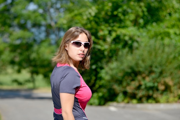 Pretty young woman doing rollerskate on a track