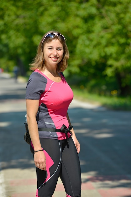 Pretty young woman doing rollerskate on a track