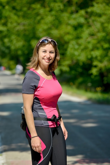 Pretty young woman doing rollerskate on a track