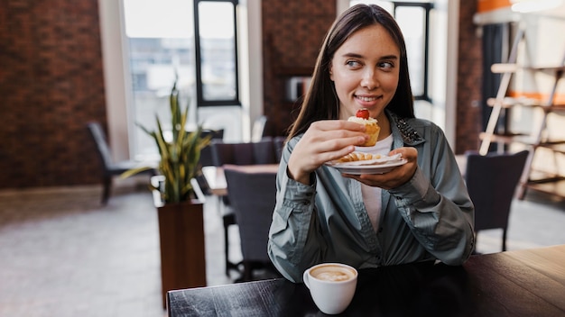 Pretty young woman enjoying a coffee break