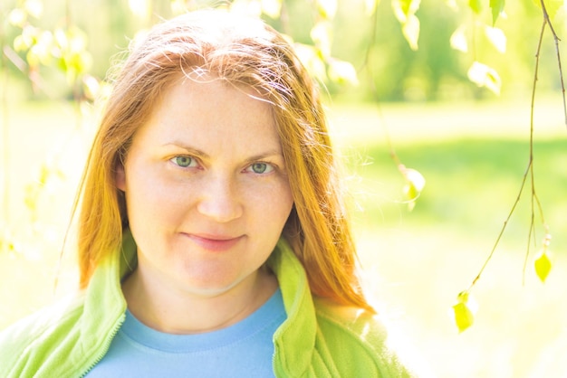 Pretty young woman face with red hair