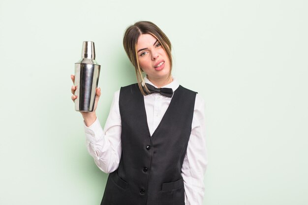 Pretty young woman feeling puzzled and confused. cocktail barman concept