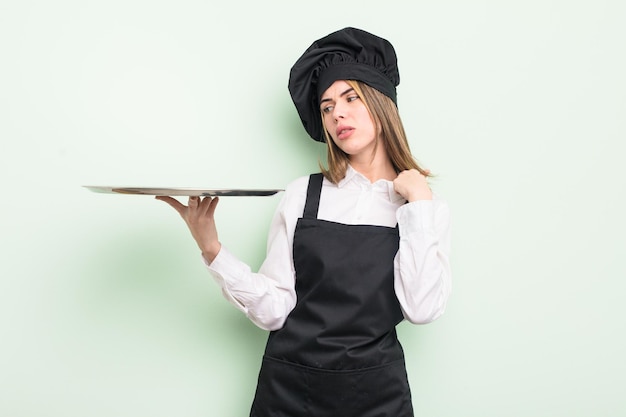 Pretty young woman feeling stressed, anxious, tired and frustrated. chef with a tray concept