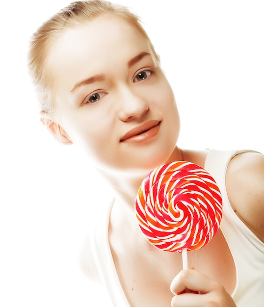 Pretty young woman holding lolly pop. Isolated on white.