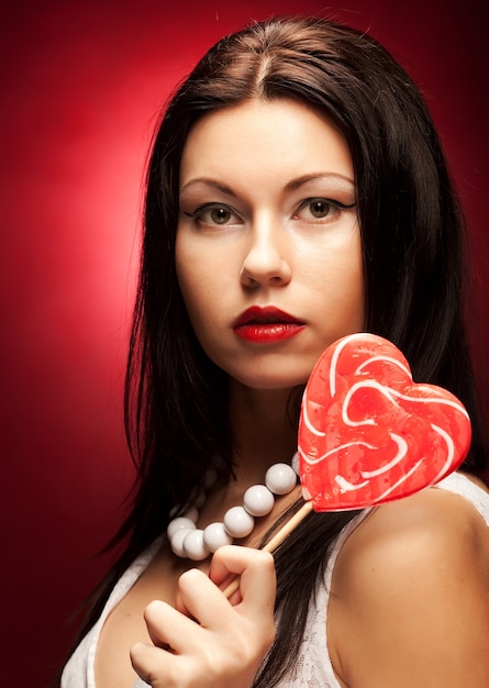 Pretty young woman holding lolly pop