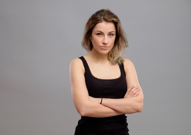 Pretty young woman isolated on gray