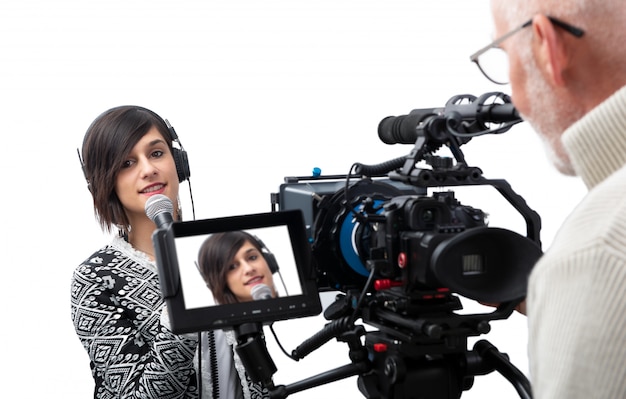 Pretty young woman  journalist presenting report in television studio on white