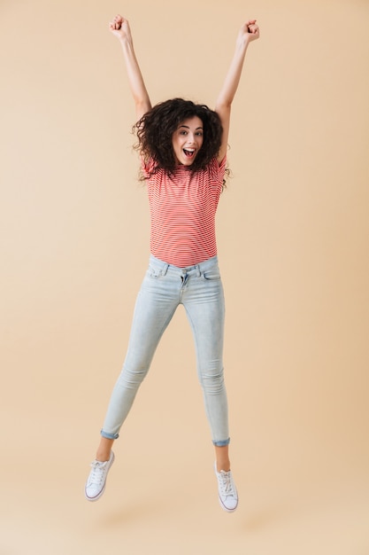 Pretty young woman jumping isolated