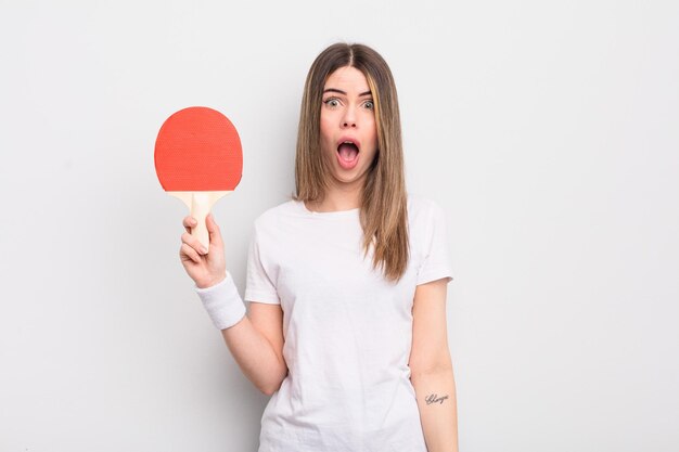 Pretty young woman looking very shocked or surprised ping pong concept