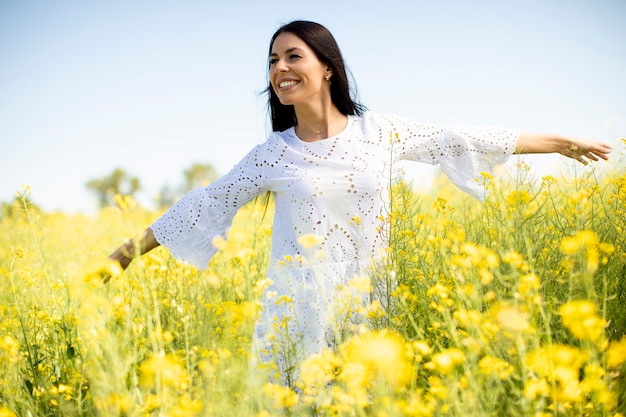 Pretty young woman in the rapeseed field