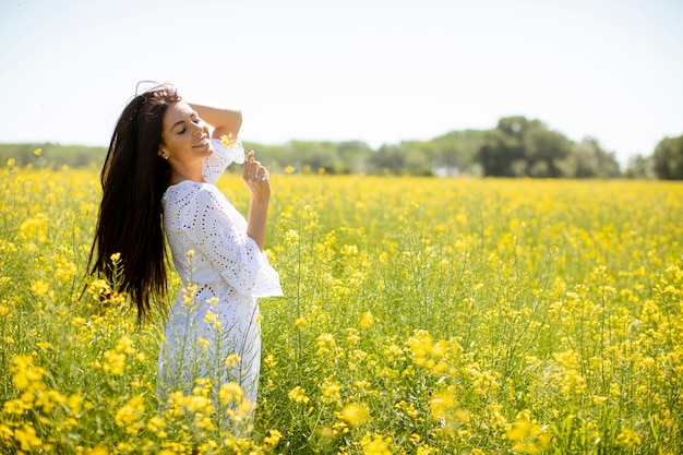 Pretty young woman in the rapeseed field