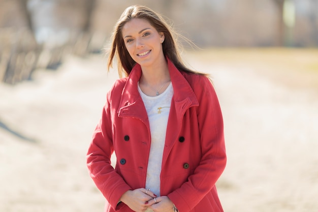 Pretty young woman in red coat