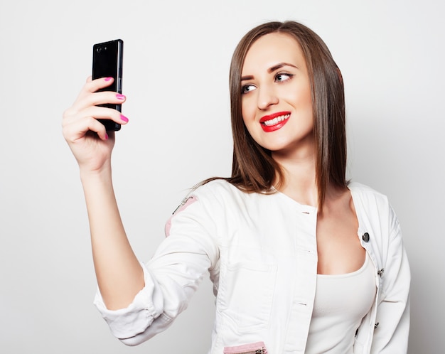 Pretty young woman using mobile phone