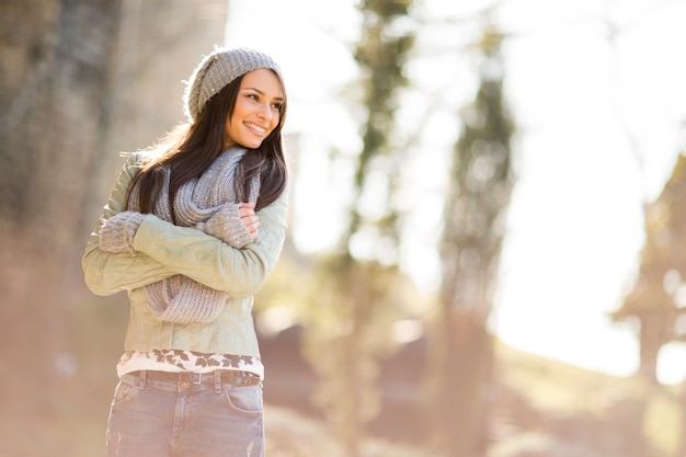 Pretty young woman with cap in the park