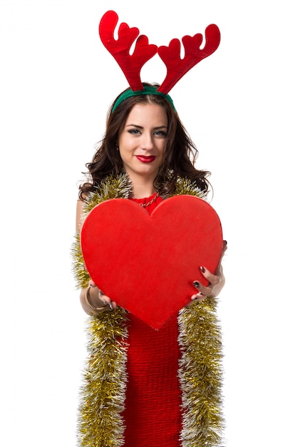 Photo pretty young woman with heart and reindeer antlers. christmas concept