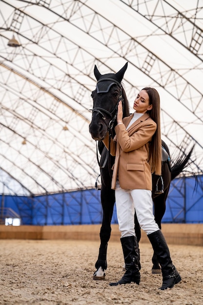 Pretty young woman with horse on countryside Beautiful outdoor ranch lifestyle