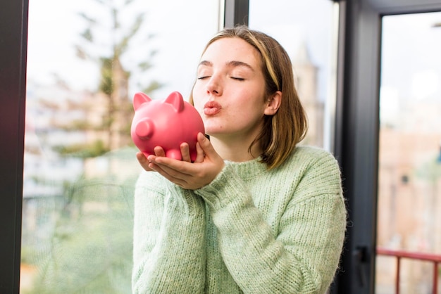 Pretty young woman with a piggy bank savings concept house interior design