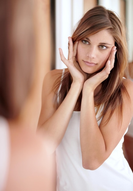 Prevention is better than cure Skincare A beautiful young woman applying lotion to her face