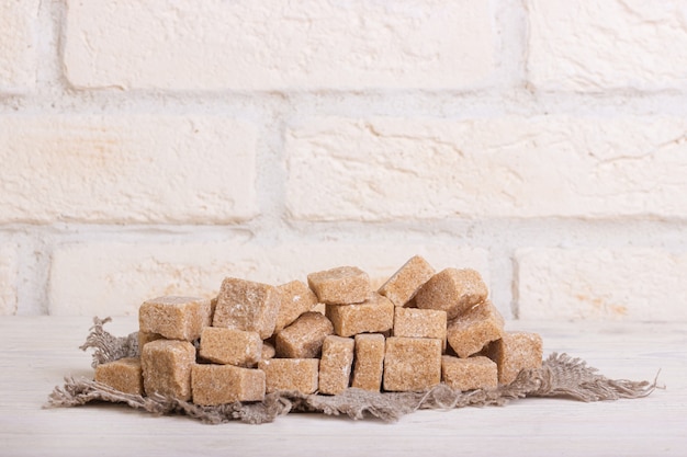 Pricked brown cane sugar on linen cloth