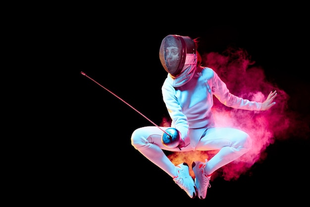 Pride Teen girl in fencing costume with sword in hand isolated on black background neon