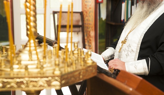 Priest praying in the church