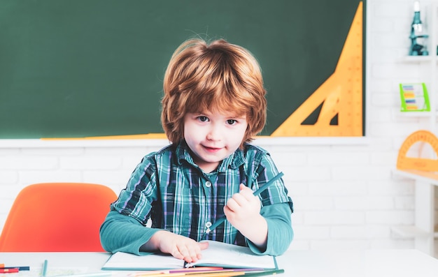 Primary school pupil School kids against green chalkboard Kid gets ready for school