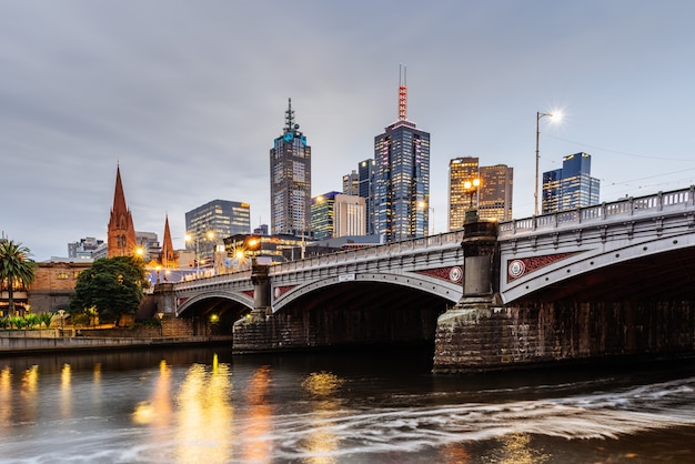 Princes Bridge and city buildings on the Yarra River in Melbourne, Australia in the evening