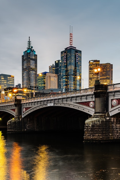 Princes Bridge and city buildings on the Yarra River in Melbourne, Australia in the evening