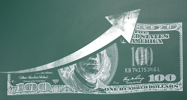 Print of a one hundreddollar American bill on a green chalkboard and an upward arrow Concept of inflation increase currency exchange rate growth