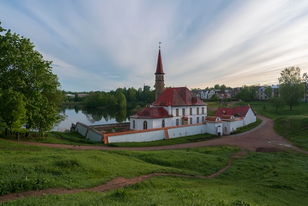 Priory Palace on the shore of the Black Lake on a summer sunny morning Gatchina St Petersburg Russia