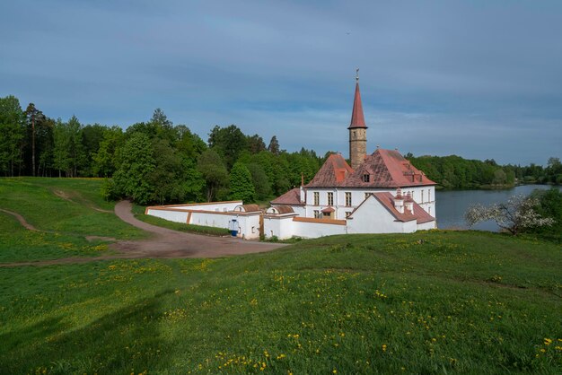 Priory Palace on the shore of the Black Lake on a summer sunny morning Gatchina St Petersburg Russia