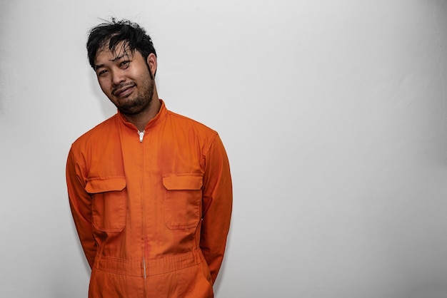 Prisoner in orange robe conceptPortrait of asian handsome man in Prison uniformsBandit has a lot of muscle