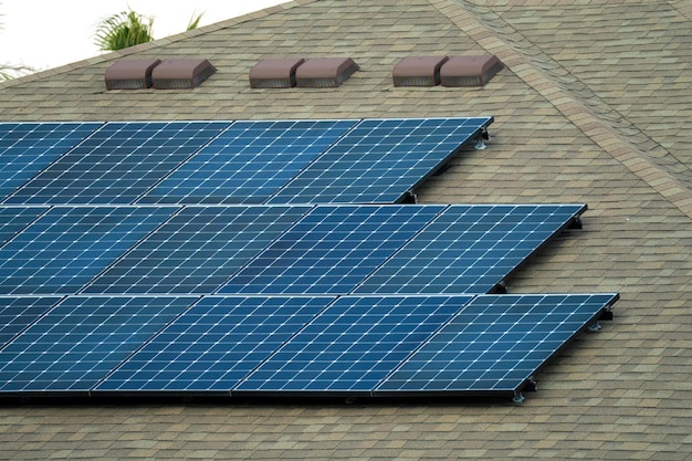 Private home roof covered with solar photovoltaic panels for generating of clean ecological electric energy in suburban rural town area Concept of autonomous house