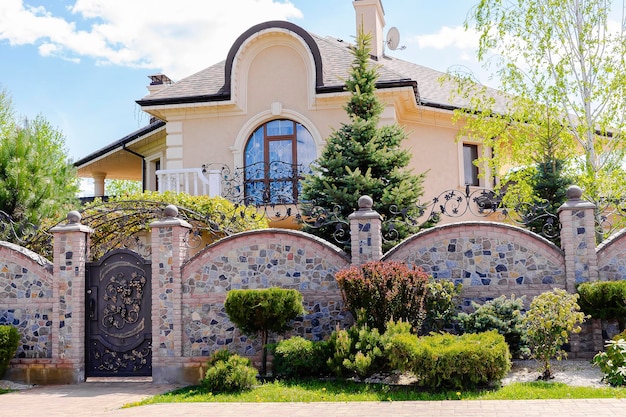 Private suburban house with backyard behind high fence beautiful landscape recreation cottage complex in ecological area with green thuja hedge Modern architecture riches and luxury concept