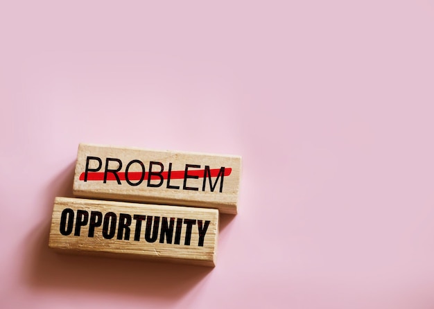 Problem crossed out and opportunity on wooden blocks Business startup concept