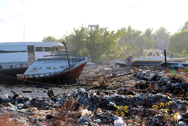 The problem of environmental pollution Garbage dump at sea Abandoned yachts Smoke in the landfill