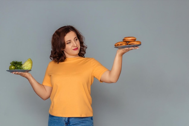 problem of weight loss and healthy eating portrait of a satisfied smiling woman in a yellow tshirt