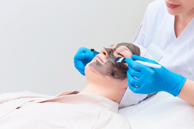 Procedure carbon facial peeling in the clinic of laser cosmetology.