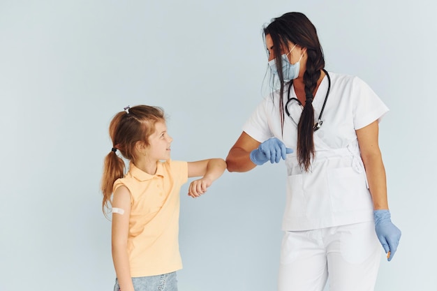 Procedure is done Doctor in uniform making vaccination to the patient