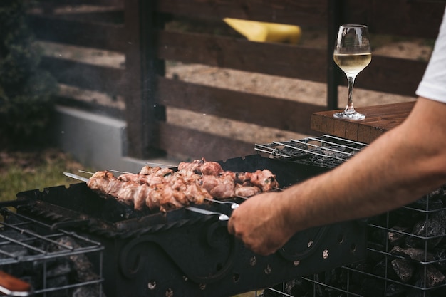 the process of cooking barbecue meat in the backyard of the house