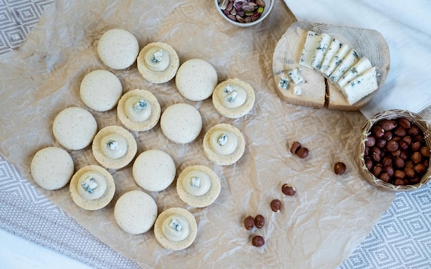 The process of cooking macaroon on a light background dorblu cheese filling