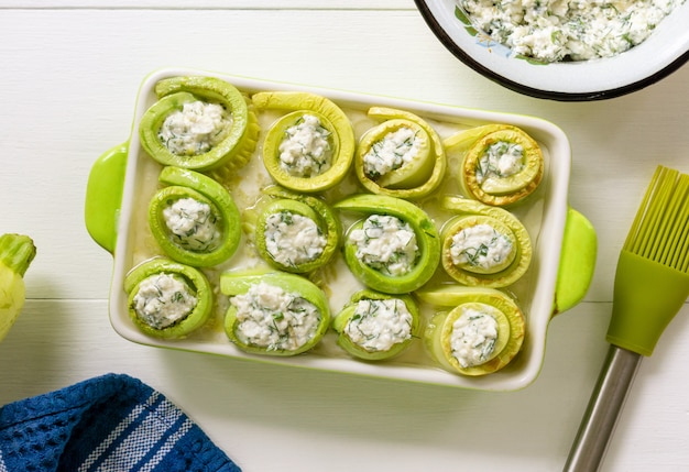 Process of cooking zucchini rolls with cottage cheese and herbs