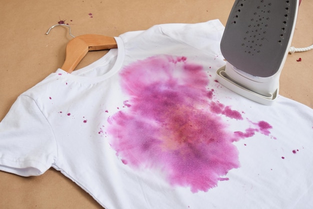 Process of dyeing clothes with rose petals using a press on a white Tshirt iron for fixing and printing natural dye