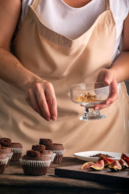 Process of making chocolate muffins Woman is cooking pastries Pastry chef fills the cupcakes with the filling