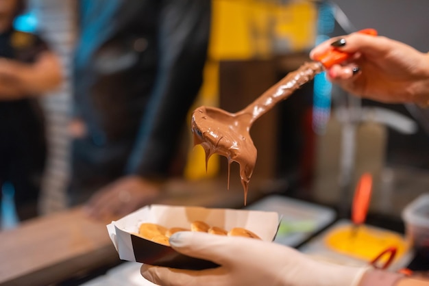 The process of making fresh delicious poffertjes Making fresh poffertjes Traditional Dutch batter treat Selective focus High quality photo